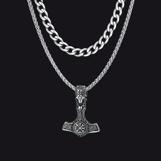 Cuban chain and Thor’s hammer pendant necklaces on flat lay with Viking props.img