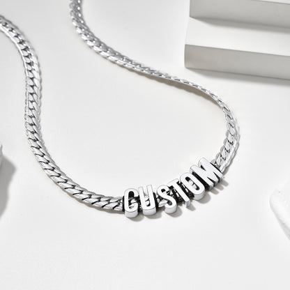 Silver chain necklace with 'CUSTOM' pendant on a white background
