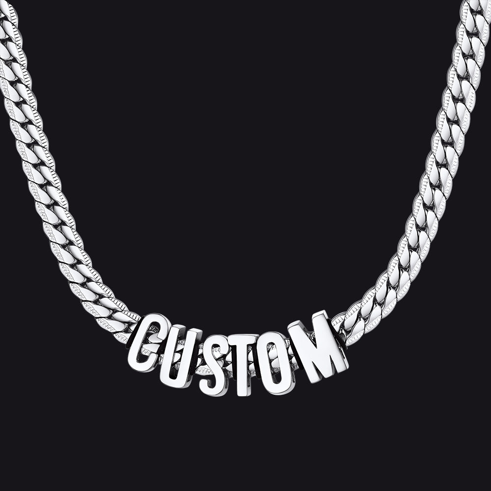 Silver chain necklace with 'CUSTOM' pendant on a black background