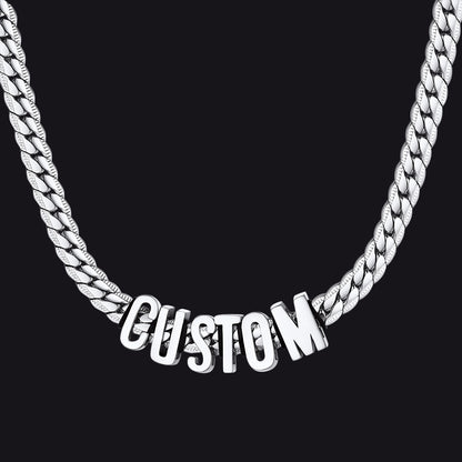 Silver chain necklace with 'CUSTOM' pendant on a black background