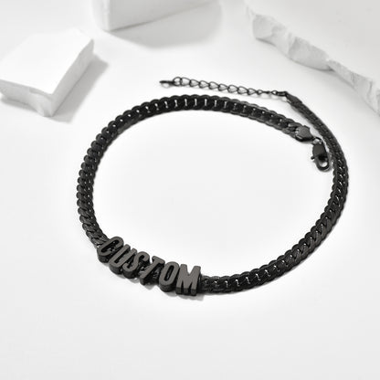 Black braided bracelet with 'CUSTOM' beads on a white background