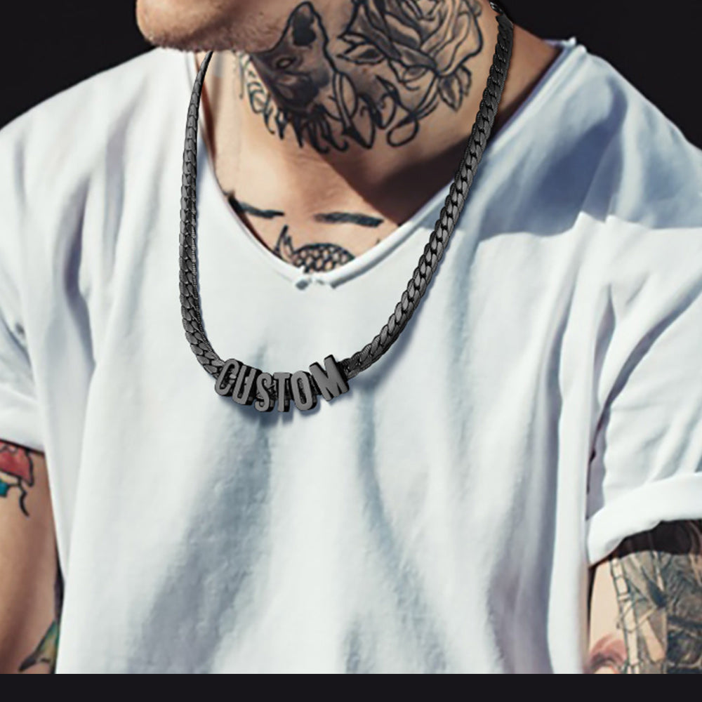 Person wearing a white t-shirt with a 'CUSTOM' necklace and tattoos on neck and arms.
