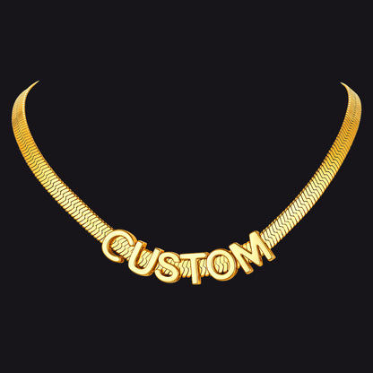 Gold necklace with 'CUSTOM' engraved on a black background