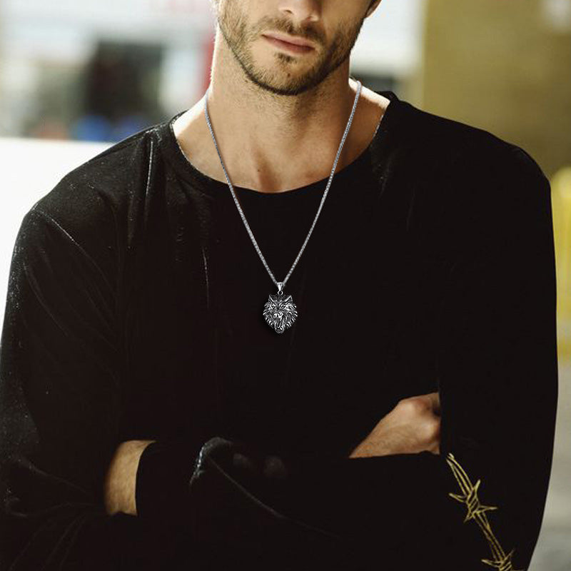 Man wearing a black long-sleeve shirt with a heart-shaped pendant necklace.