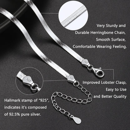 Silver necklace with herringbone chain and lobster clasp on a dark background