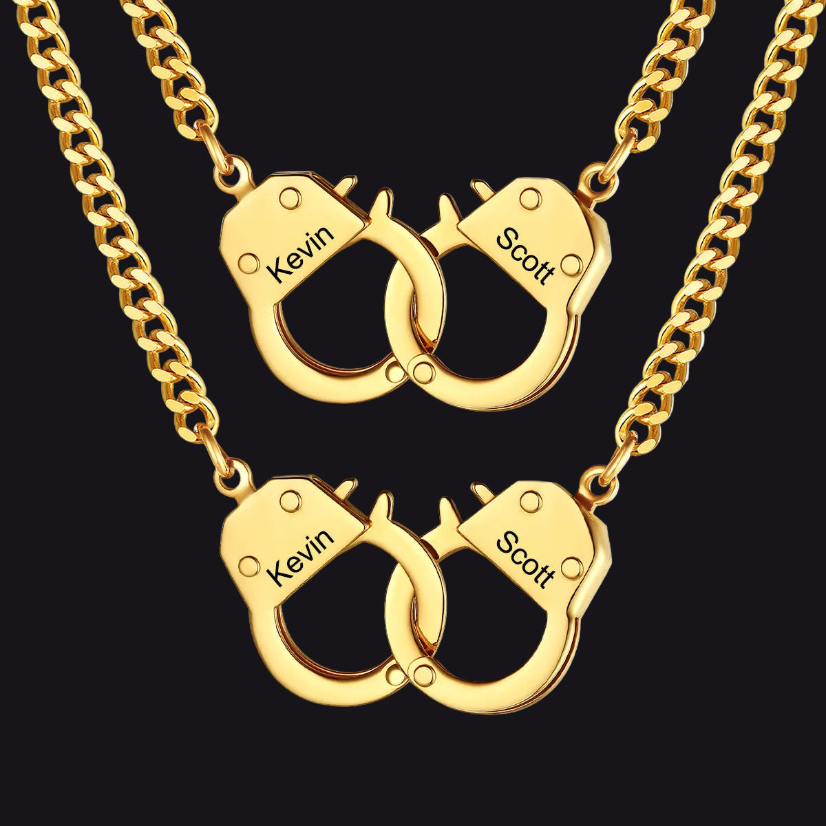 Two gold-toned chain necklaces with interlocking handcuff-shaped pendants.