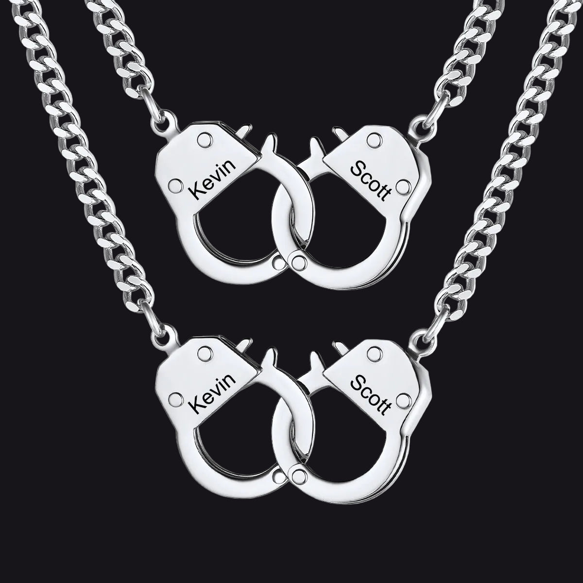 Two matching silver chain necklaces with interlocking handcuff pendants 