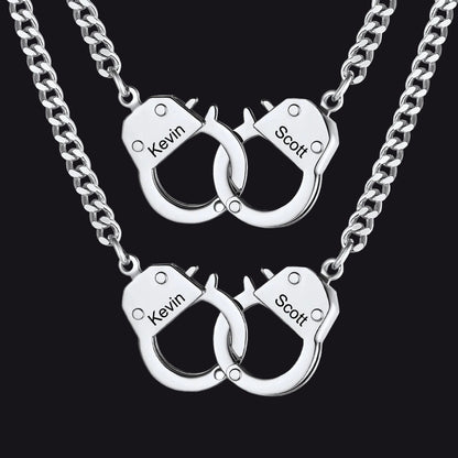 Two matching silver chain necklaces with interlocking handcuff pendants 