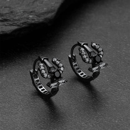 Pair of black Poseidon Trident Greek hoop earrings with gemstones on a dark surface