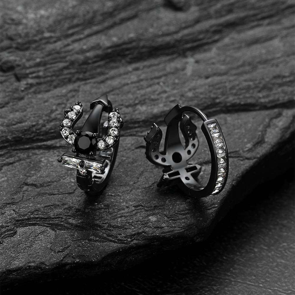 Pair of black Poseidon Trident Greek r hoop earrings on a dark stone surface