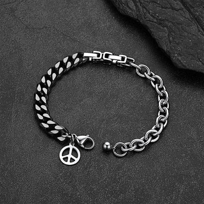 Black and silver Cuban link bracelet against a dark gray rock background.