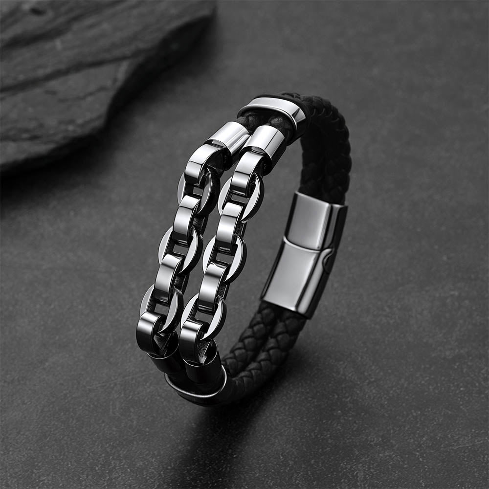 Punk-Gothic style leather bracelet on a dark gray rock background.