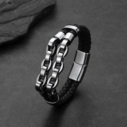 Punk-Gothic style leather bracelet on a dark gray rock background.