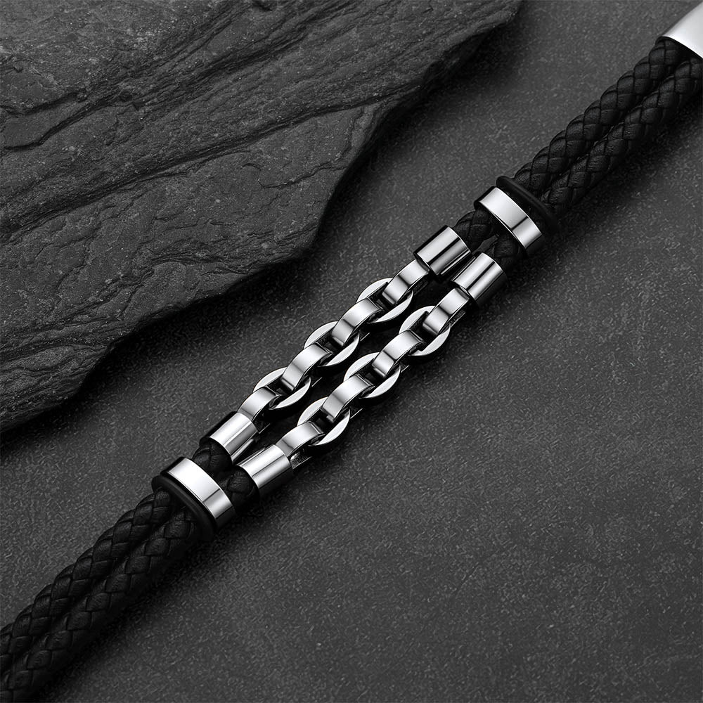 Punk-Gothic style leather bracelet on a dark gray rock background.