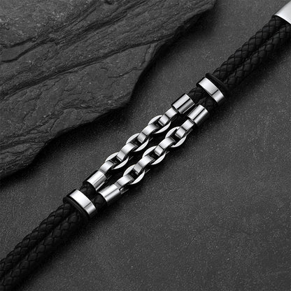 Punk-Gothic style leather bracelet on a dark gray rock background.