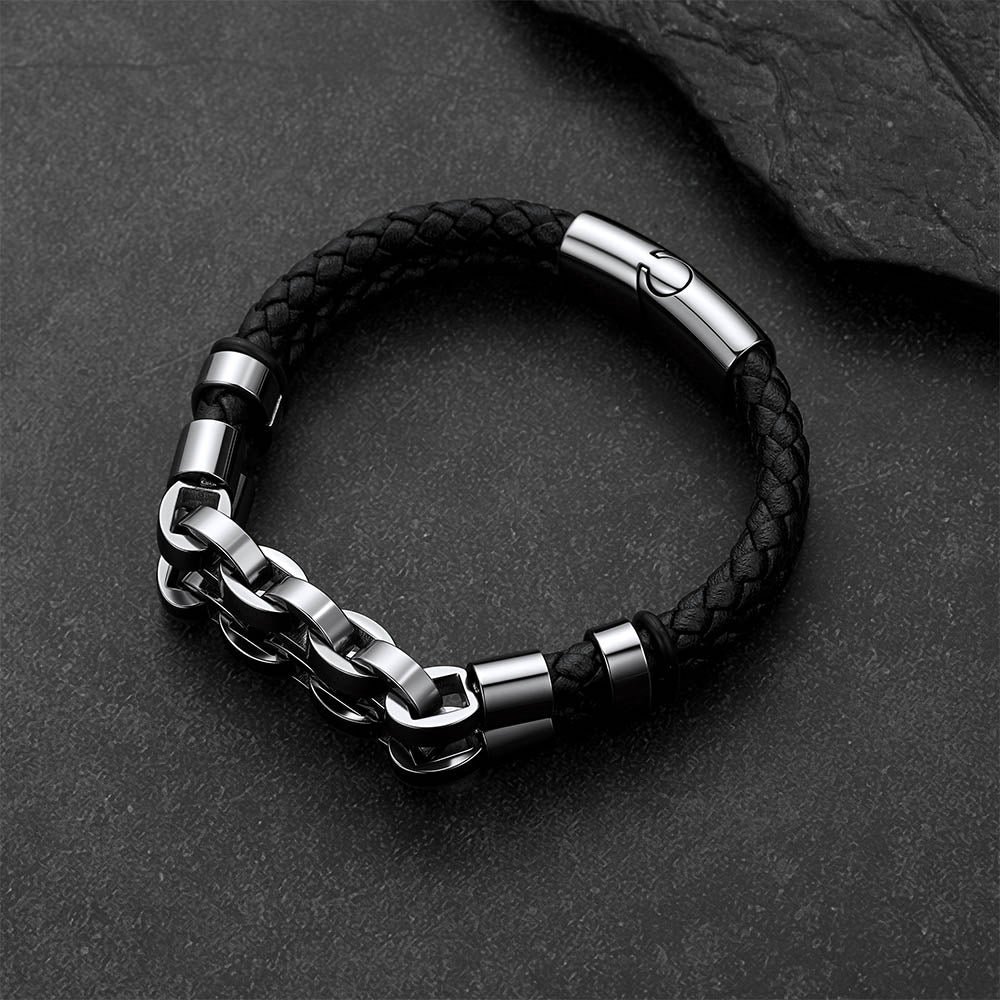 Punk-Gothic style leather bracelet on a dark gray rock background.