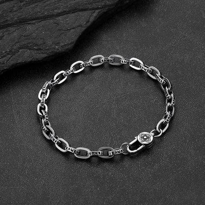 Close-up of engraved paperclip chain bracelet with cyberpunk font lettering