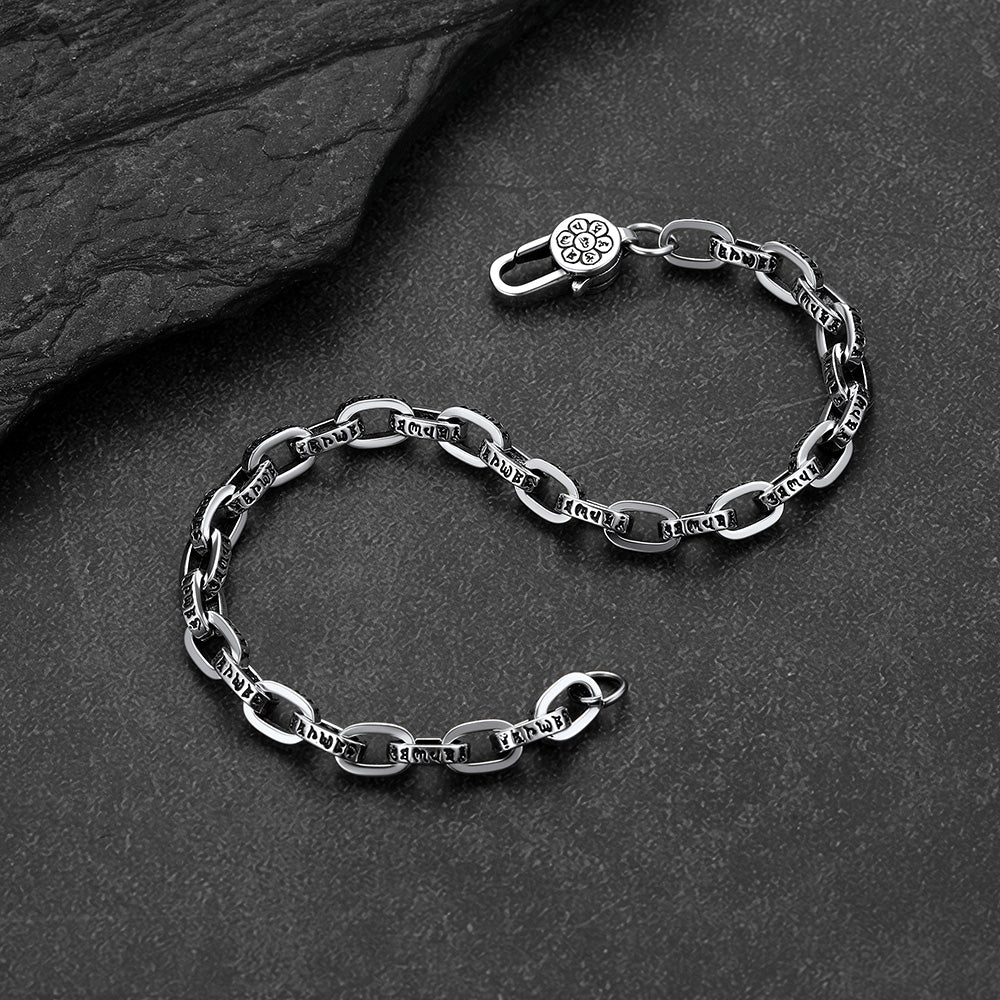 Close-up of paperclip chain bracelet with cyberpunk font lettering