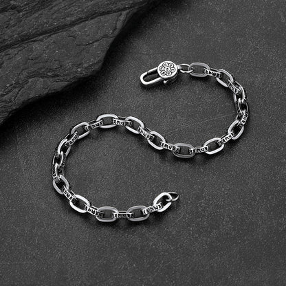 Close-up of paperclip chain bracelet with cyberpunk font lettering