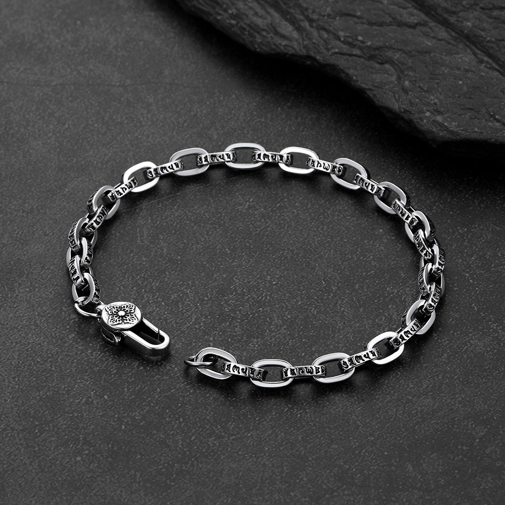 Close-up of engraved paperclip chain bracelet with cyberpunk font lettering,