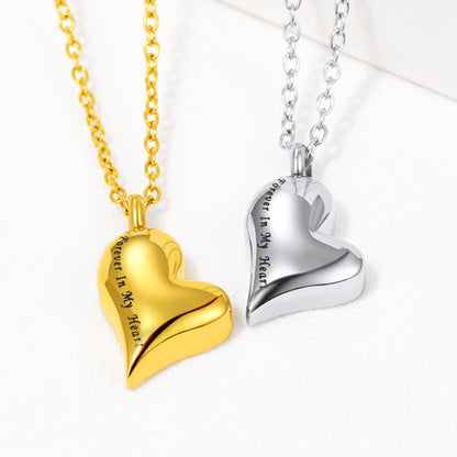 Flat lay of engraved heart pendant in silver/gold