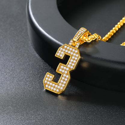 Gold necklace with a number '3' pendant on a black background