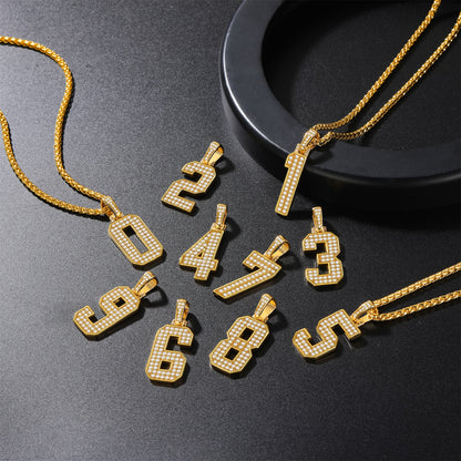 Gold number pendants on a dark surface