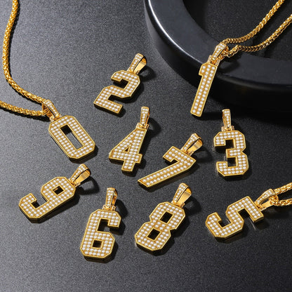 Gold number pendants on a dark surface