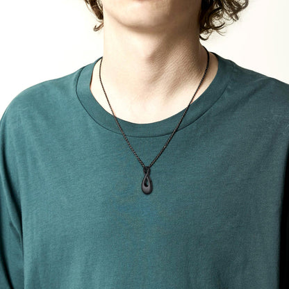 Man wearing engraved infinity urn necklace with simple, heartfelt styling
