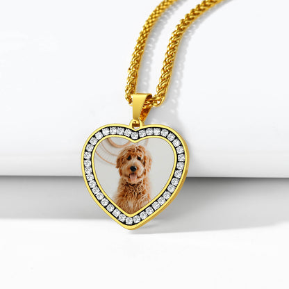 Gold heart-shaped pendant with a photo of a dog on a white background