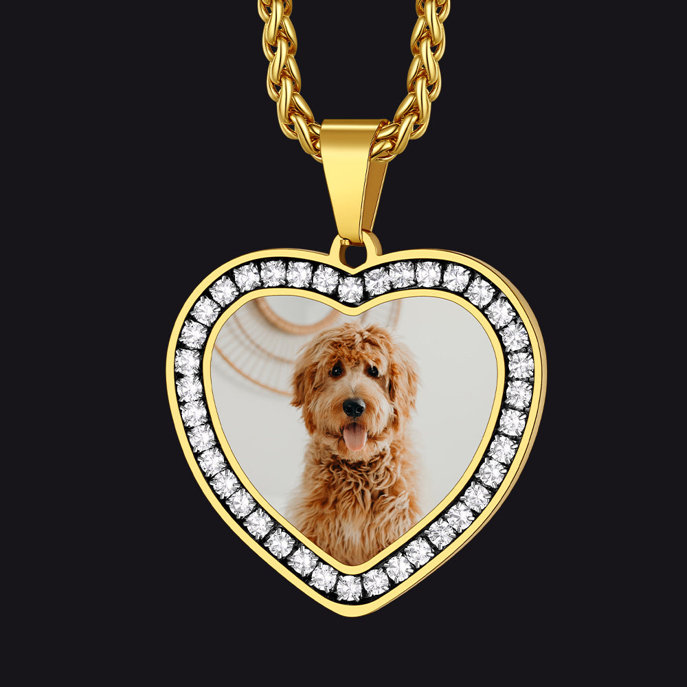 Gold heart-shaped pendant with a photo of a dog inside, on a black background