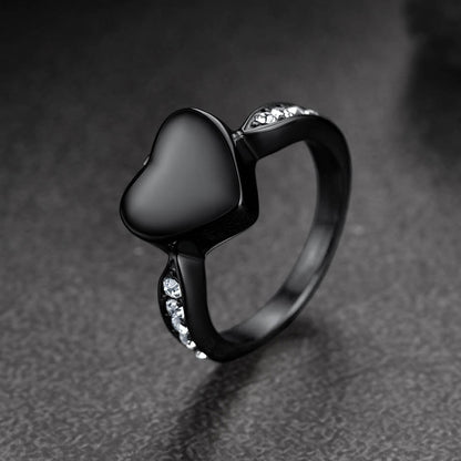 Black heart-shaped ring with gemstones 