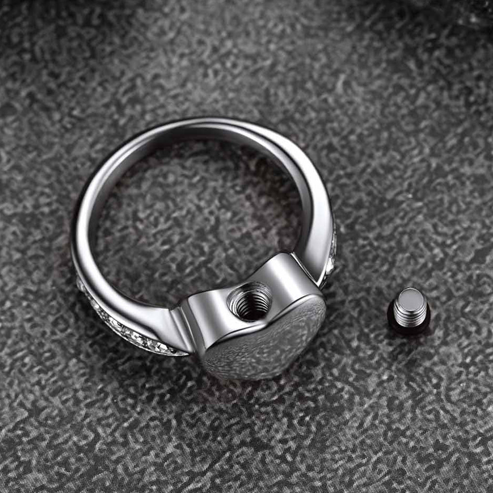 Silver ring with a unique design on a textured gray surface