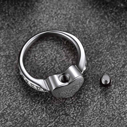 Silver ring with a unique design on a textured gray surface