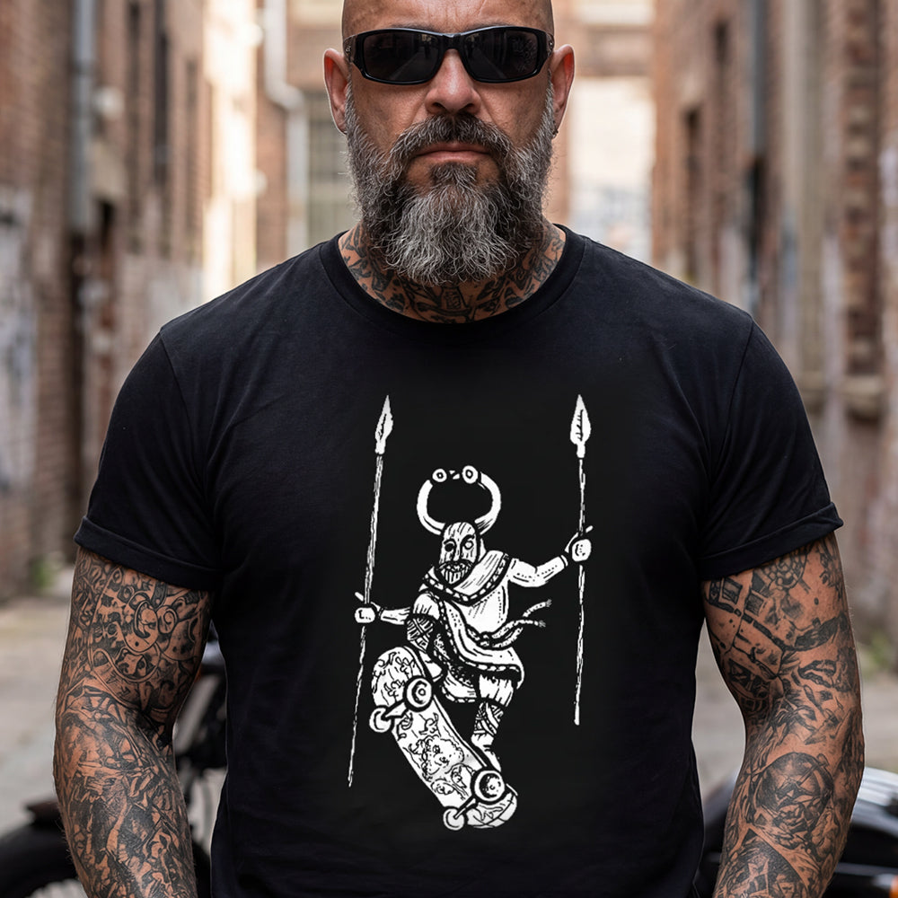 Man wearing a black Skateboarding Viking T-Shirt with a white graphic design in an urban setting