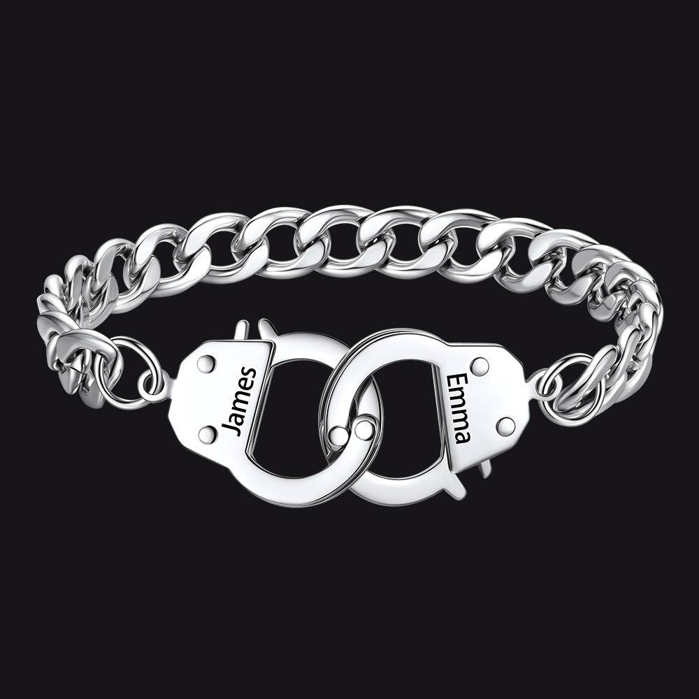 Silver chain bracelet with interlocking handcuffs engraved with names on a black background