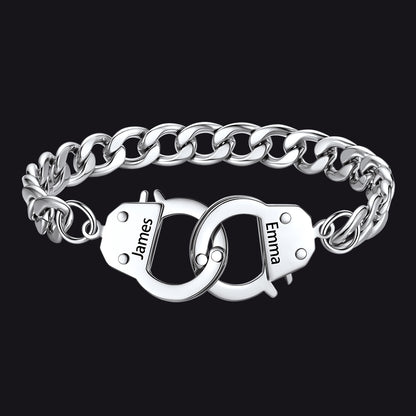 Silver chain bracelet with interlocking handcuffs engraved with names on a black background