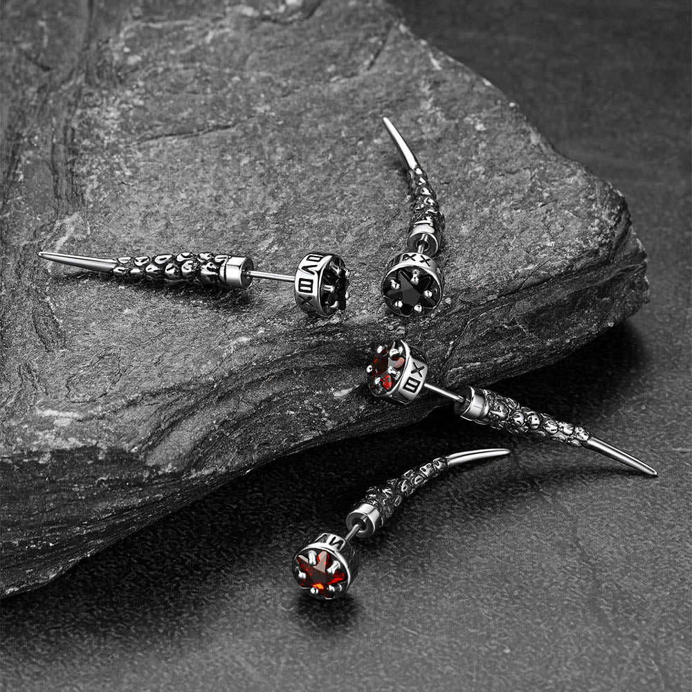 Silver earrings with gemstones on a stone surface