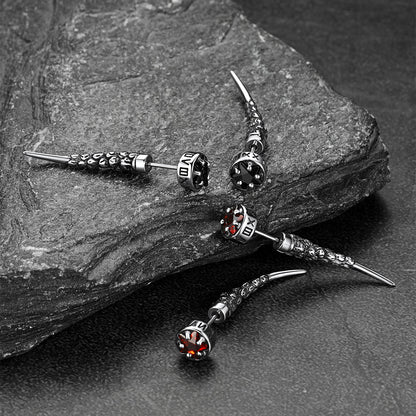 Silver earrings with gemstones on a stone surface