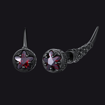 Pair of black and red earrings on a black background