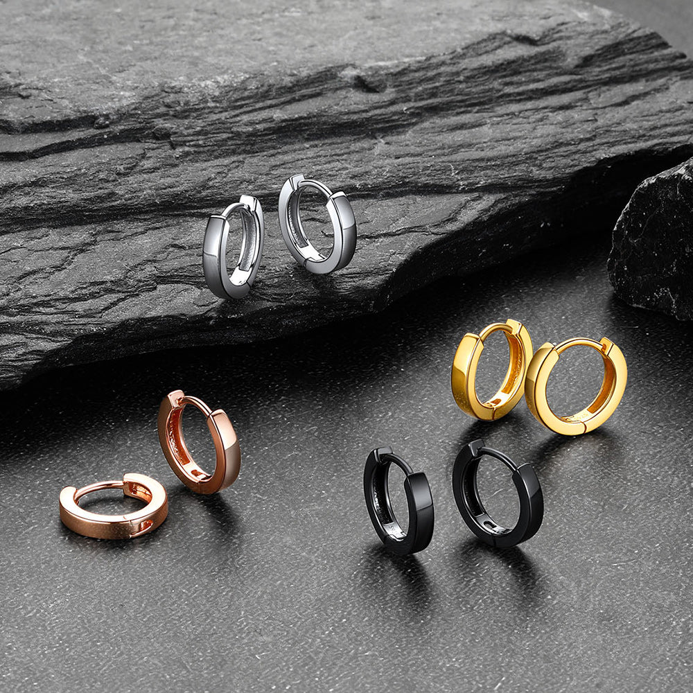 Set of hoop earrings in various colors on a dark stone surface