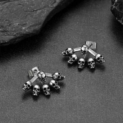 Gothic multiple skull stud earrings photographed with Halloween props.