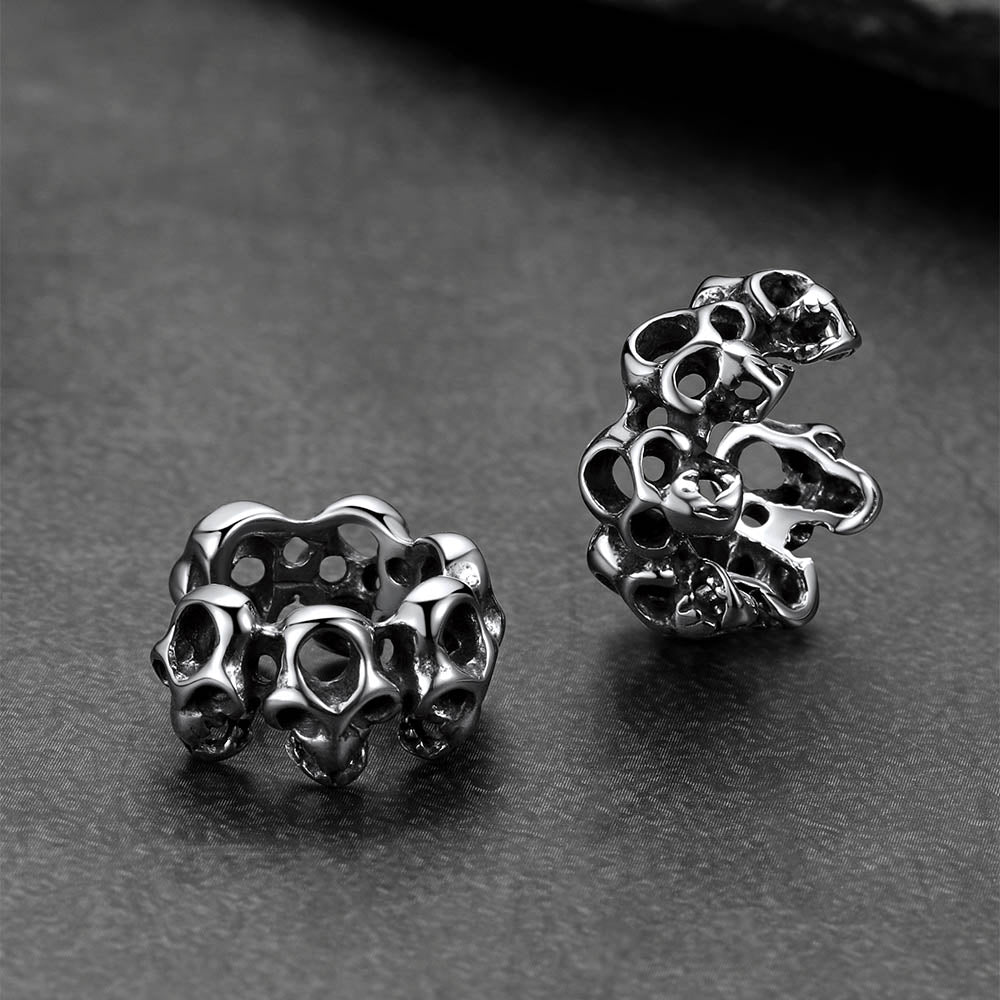 Gothic skull ear cuff photographed with Halloween pumpkin props.