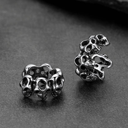 Gothic skull ear cuff photographed with Halloween pumpkin props.