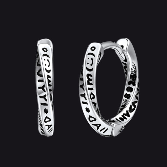 Silver hoop earrings with intricate designs on a black backgroundimg
