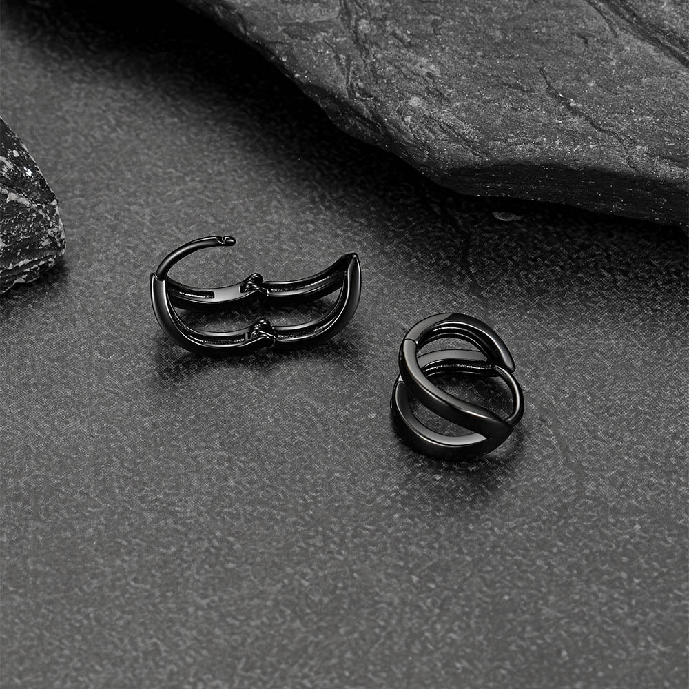 Close-up of black hoop huggie earrings for men and women