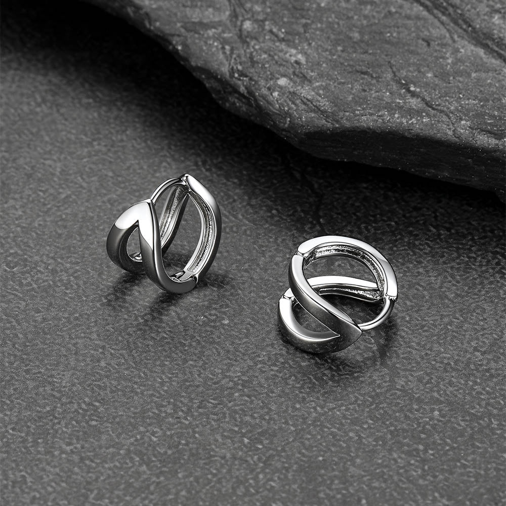 Close-up of black hoop huggie earrings for men and women