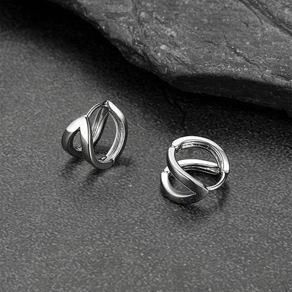 Close-up of black hoop huggie earrings for men and women