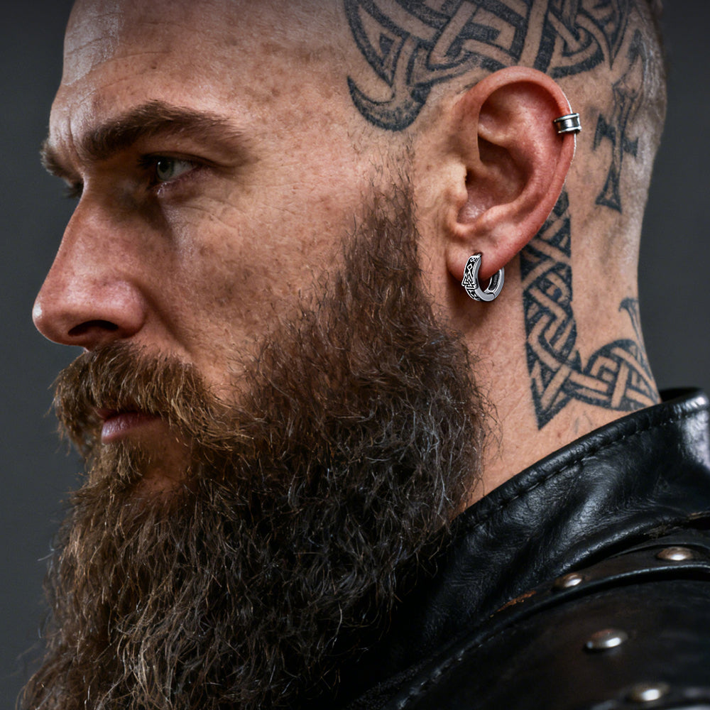 Man with beard and tattoos wearing a Valknut Amulet Hoop Earrings
