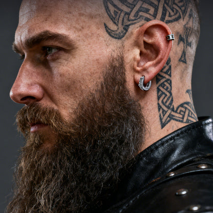 Man with beard and tattoos wearing a Valknut Amulet Hoop Earrings